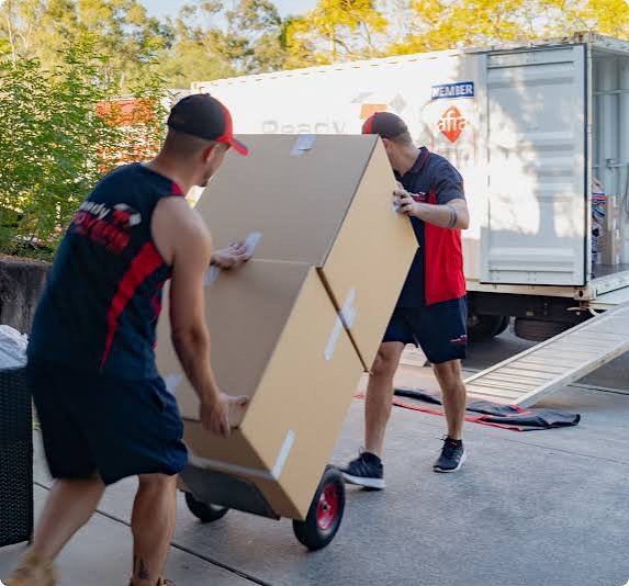 Movers handling a large box